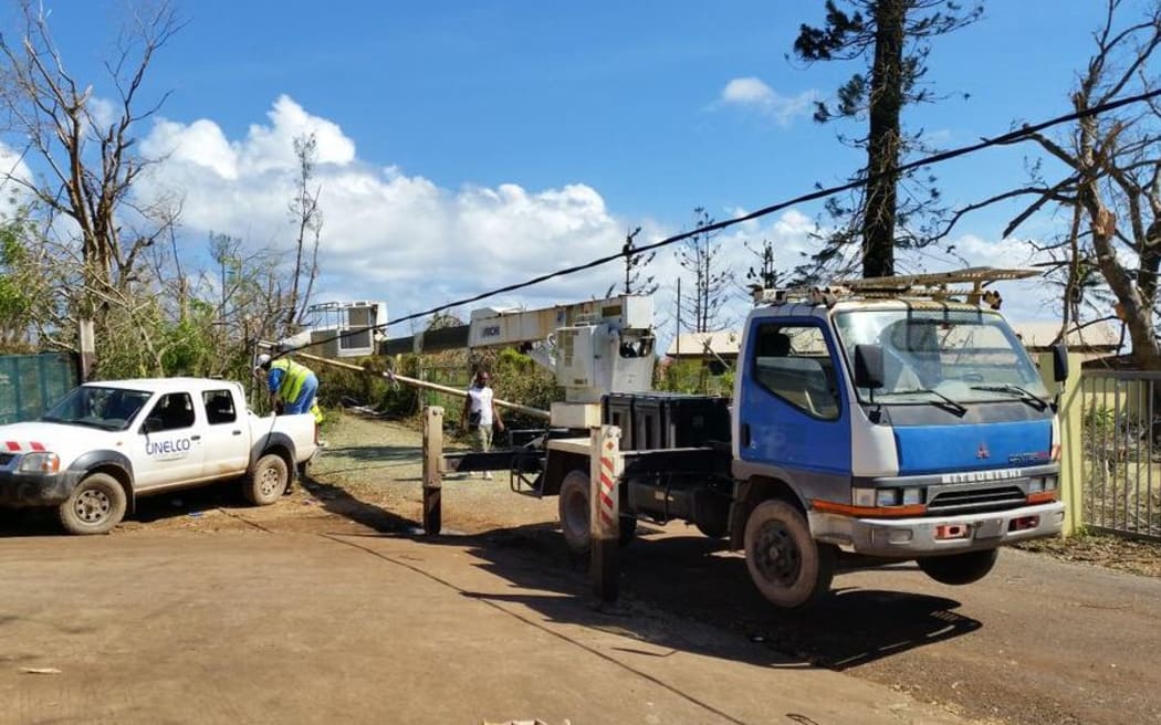 Workers from Vanuatu's electricity provider UNELCO repair power lines