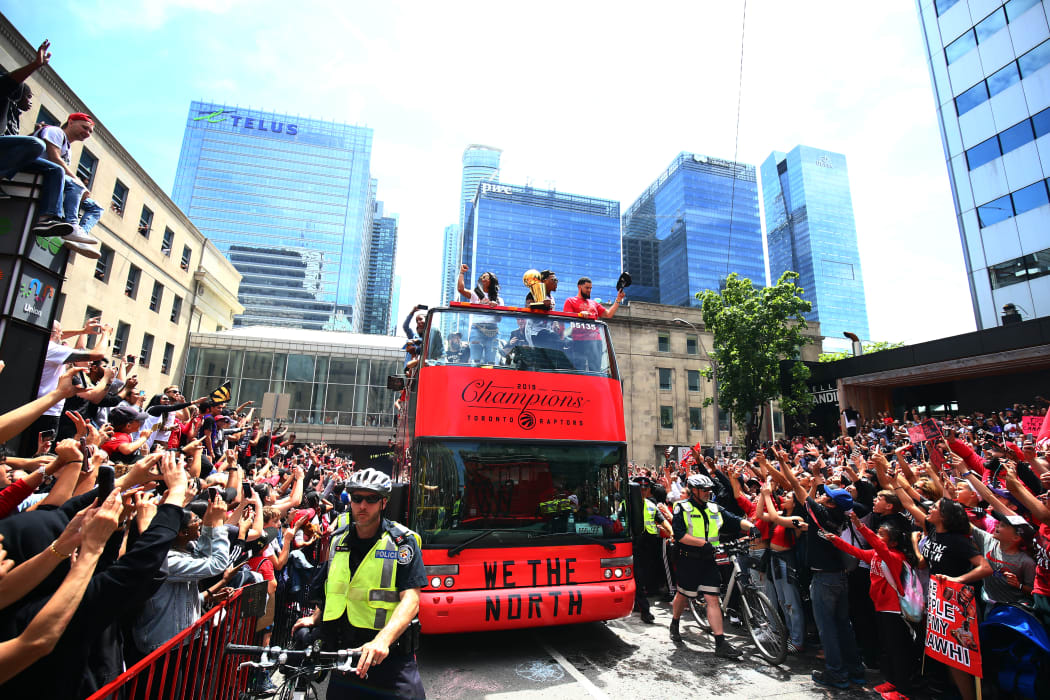 TORONTO, ON - JUNE 17: Kyle Lowry #7 and Fred VanVleet #23 of the Toronto Raptors with the championship trophy during the Toronto Raptors Victory Parade on June 17, 2019 in Toronto, Canada.