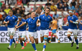 Italy's right wing Lorenzo Pani (CR) is congratulated by Italy's inside centre Paolo Garbisi (CL) as he celebrates after scoring Italy's first try during the France 2023 Rugby World Cup Pool A match between Italy and Uruguay at Stade de Nice in Nice, southern France on September 20, 2023.