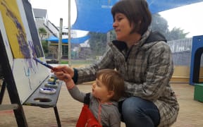 Fiona Roberton helps her daughter Kate (17-months) paint at Newtown Playcentre.