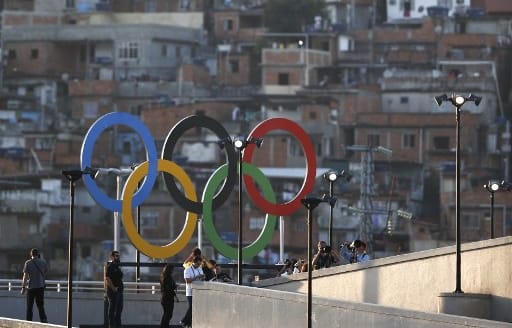 Olympic rings overlook a favela outside the Maracana stadium in Rio.