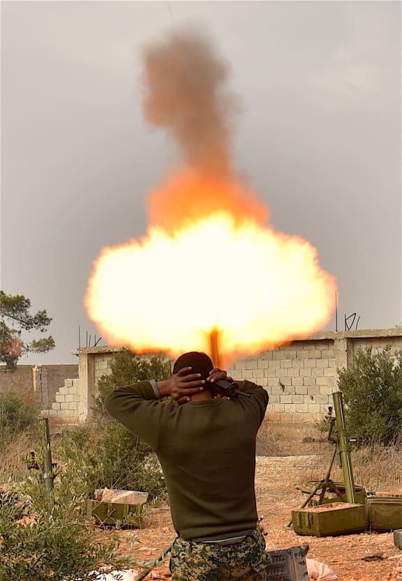 A soldier of pro-government militia fires mortar to rebel-held areas in Aleppo, Syria, on Dec. 11, 2016.