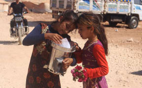 Syrian Girls with Escea 'Fire For Life' Stove