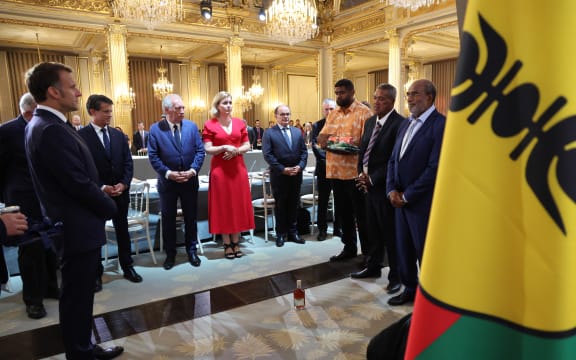 France's President Emmanuel Macron (L), France's Minister of Overseas Manuel Valls, France's Prime Minister Francois Bayrou, President of the French National Assembly Yael Braun-Pivet, Secretary General of the French Presidency Emmanuel Moulin, first vice-president of the customary senate of New Caledonia Ludovic Boula, representative of the second vice-president of the customary senate Victor Gogny, and President of the customary senate Aguetil Mahe Gowe attend a custom ceremony as the inauguration of a summit on New Caledonia at the Elysee Palace in Paris on July 2, 2025. After months of “patient work” and three return trips to New Caledonia, France's Minister of Overseas is hoping to reach a compromise between independentists and loyalists at the “summit” that begins on July 2. (Photo by Ludovic MARIN / POOL / AFP)