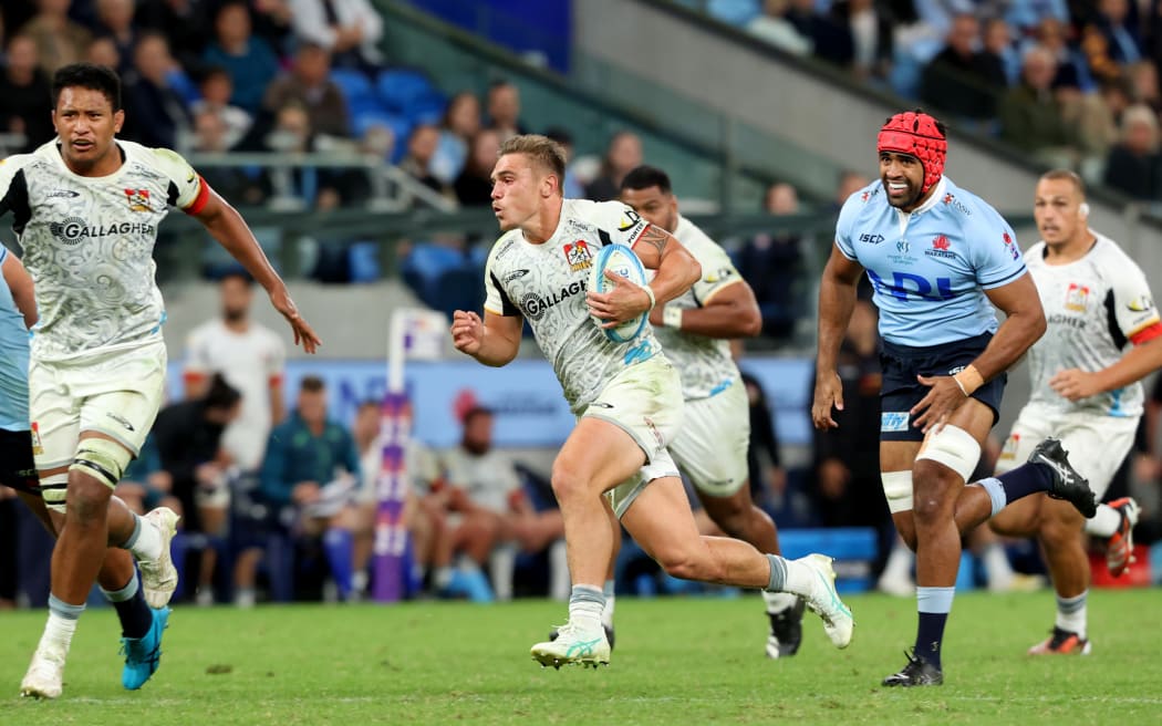 Chiefs halfback Cortez Ratima makes a break against the Waratahs.