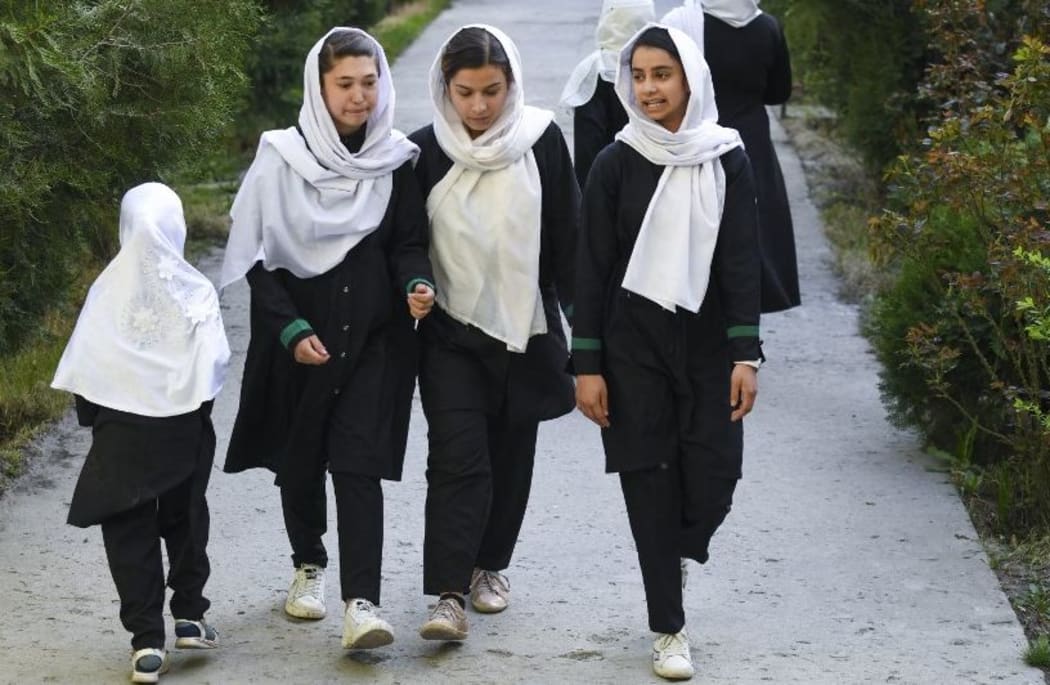 CAPTION ADDITION - updated information - 
Girls arrive at their school in Kabul on March 23, 2022. - The Taliban ordered girls' secondary schools in Afghanistan to shut on March 23 just hours after they reopened,