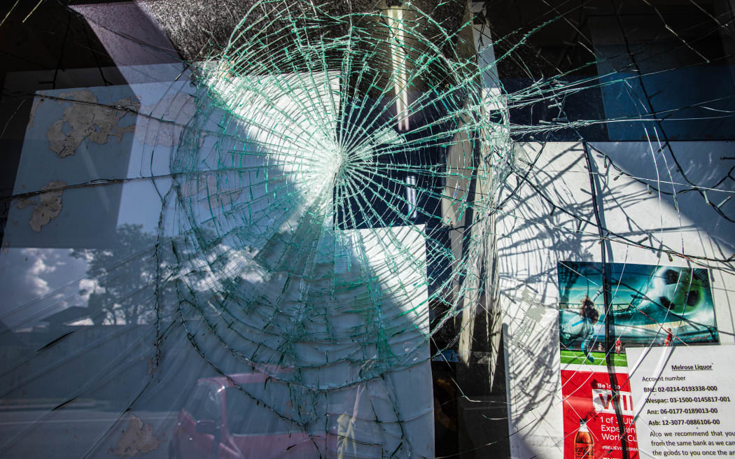 Melrose Liquor store's manager says a person who was locked in the shop after trying to take the till tried to break out through the door's window.