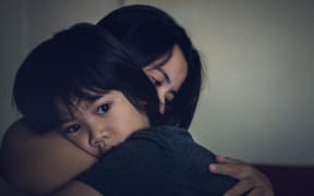 83600651 - mother and child, cute little boy resting on her mother's shoulder. young mother holding her sad boy at home.