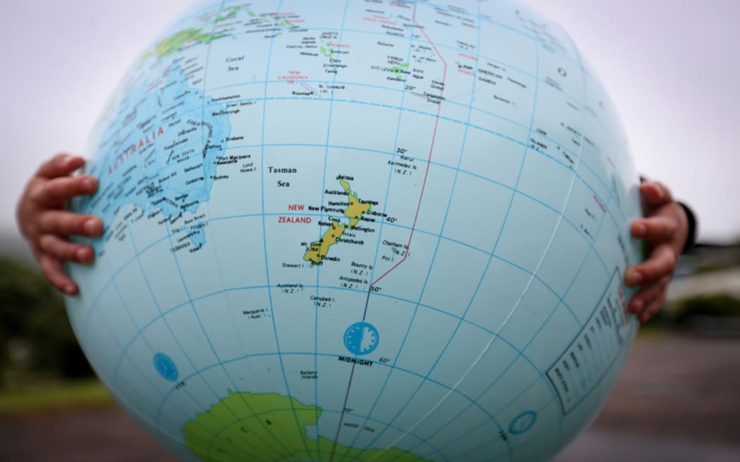 A kid from Hampton Hill Primary holds up the world.