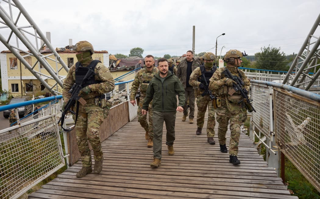 Ukrainian President Volodymyr Zelensky (C) walking during his visit to de-occupied city of Izium, Kharkiv region. Zelensky visited the east Ukraine city - one of the largest recently recaptured from Russia by Kyiv's army in a lightning counter-offensive - on 14 September, 2022, the military said.