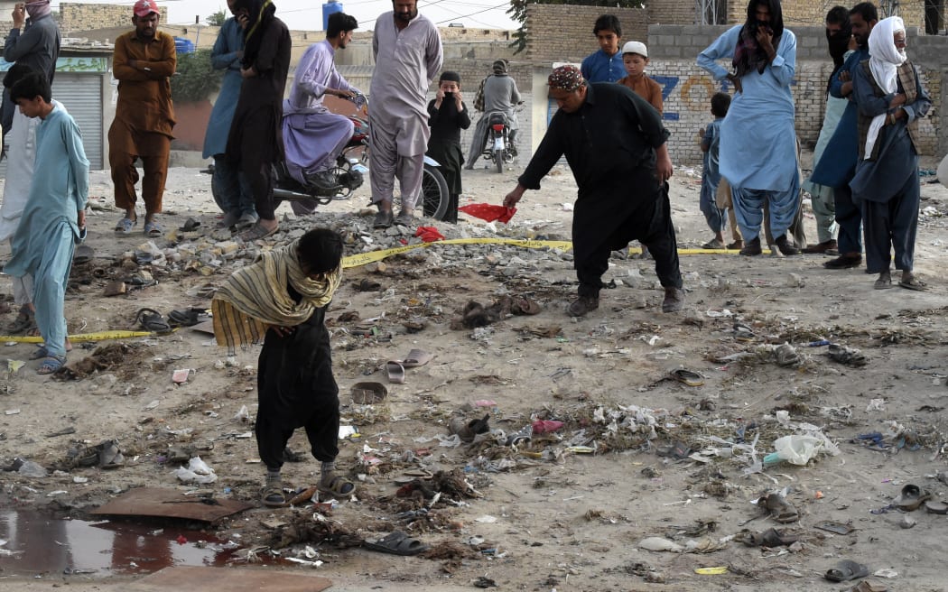 People gather at the site of a suicide bomb attack that targeted a procession marking the birthday of Islam's Prophet Mohammed in Mastung district on September 29, 2023. More than 50 people were killed and dozens more wounded in Pakistan's Balochistan province on September 29 by a suicide bomber targeting a procession marking the birthday of Islam's Prophet Mohammed, officials said. (Photo by Banaras KHAN / AFP)