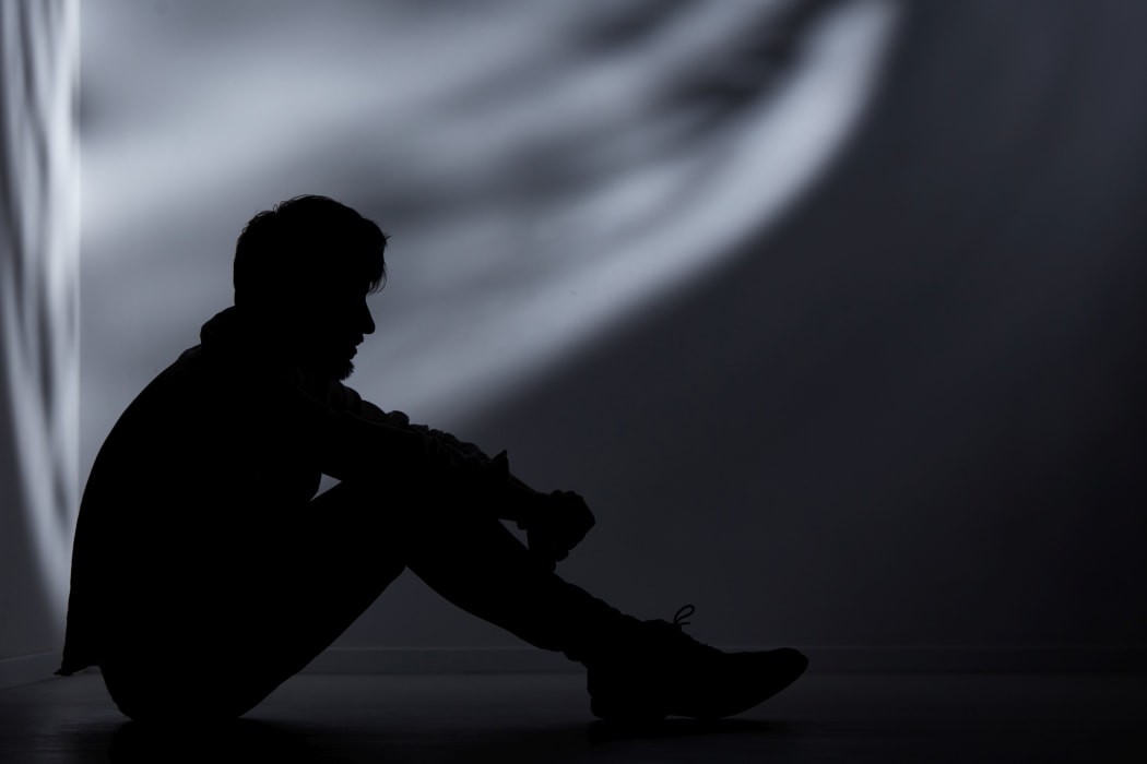 Abandoned man in dark room.