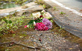 Flowers at the scene where car was washed away