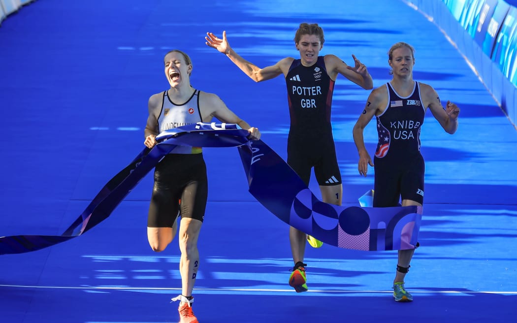 Laura Lindemann of Germany wins the mixed triathlon relay race at the Paris Olympics.