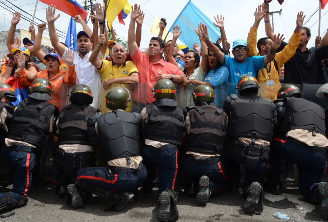 Police block protesters trying to reach the National Electoral Council on May 18, 2016 in Valencia, Venezuela.Police and protesters clashed across the country at nationwide rallies demanding a recall referendum of President Nicolas Maduro.