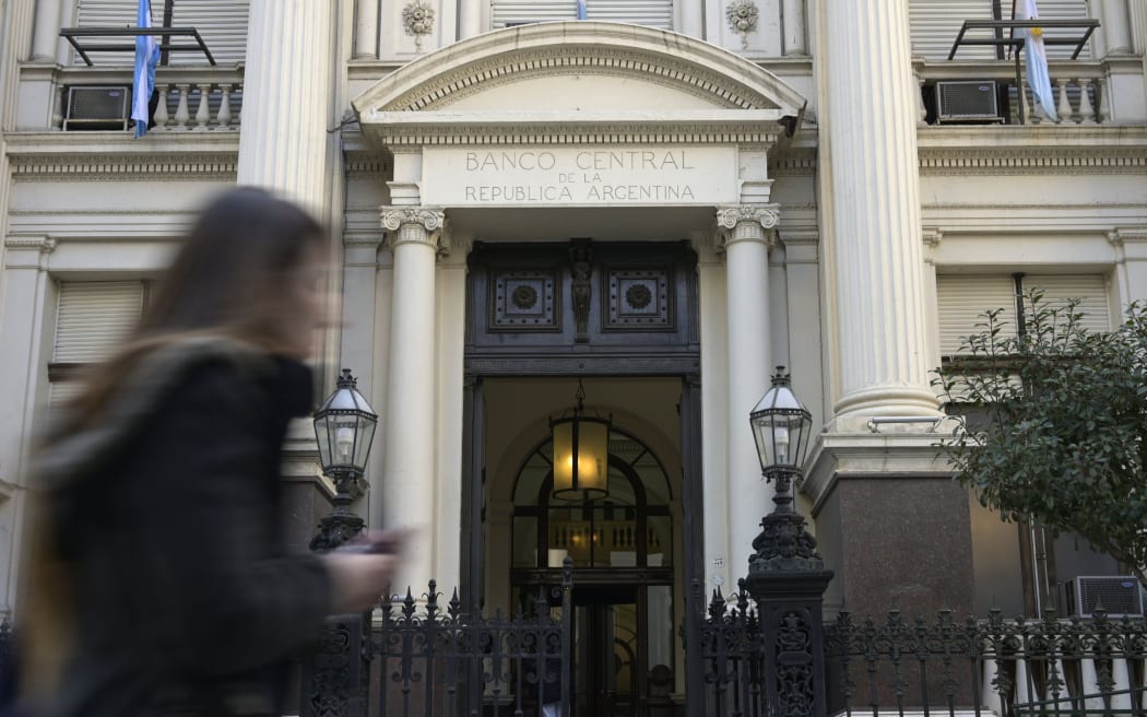 A woman passes by the headquarters of Argentina's Central Bank in the financial district of Buenos Aires