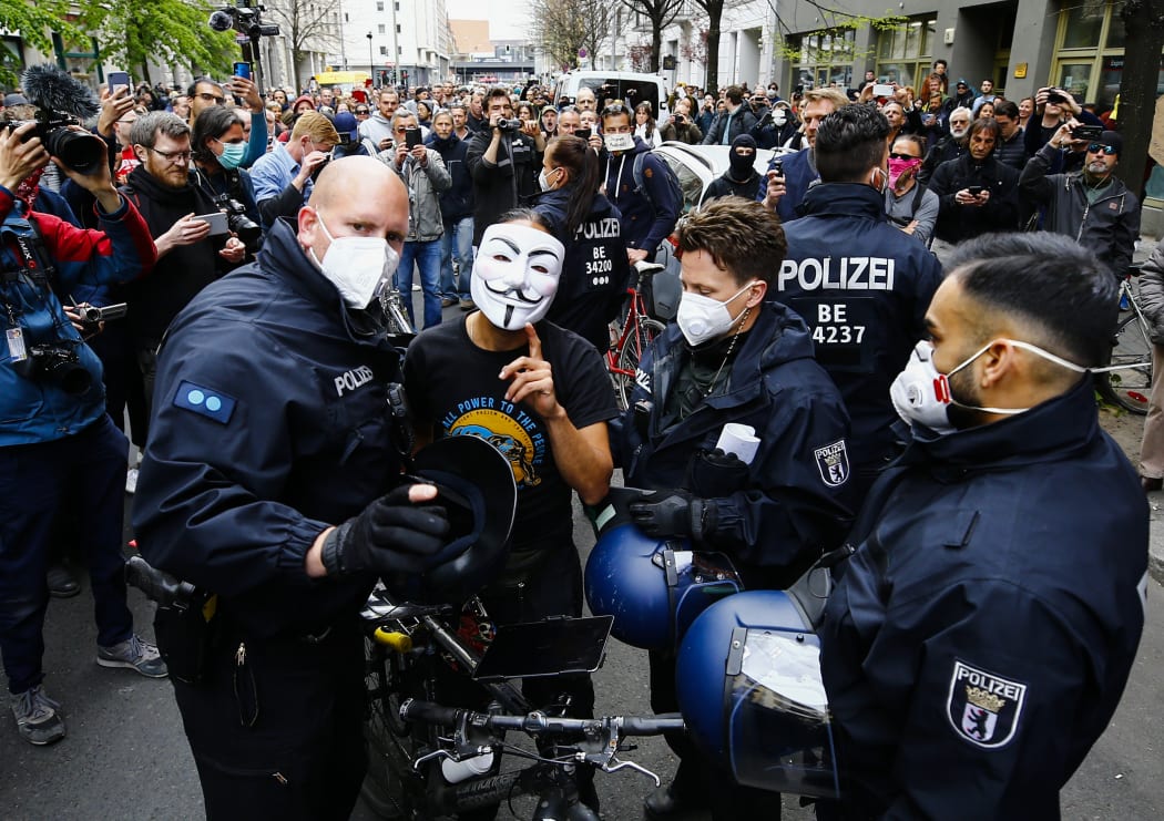 BERLIN, GERMANY - APRIL 25: Police officers wearing protective mask, take a man into custody during a protest against restrictions taken against the novel coronavirus (Covid-19) pandemic in Berlin, Germany on April 25, 2020. Abdulhamid Hosbas / Anadolu Agency