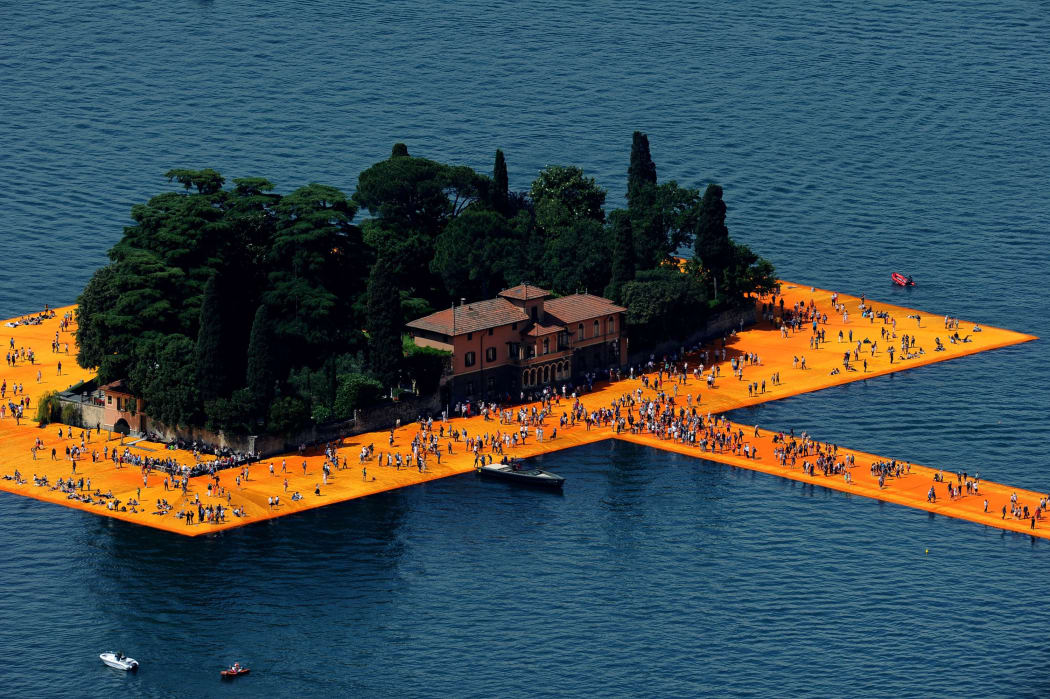 People visit the installation 'The Floating Piers' on the Iseo Lake, installed by the Bulgarian artist Christo Vladimirov Javacheff, In June, 2016 in Brescia, Italy.