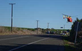 A rescue helicopter takes off from the scene of a crash that claimed five lives.