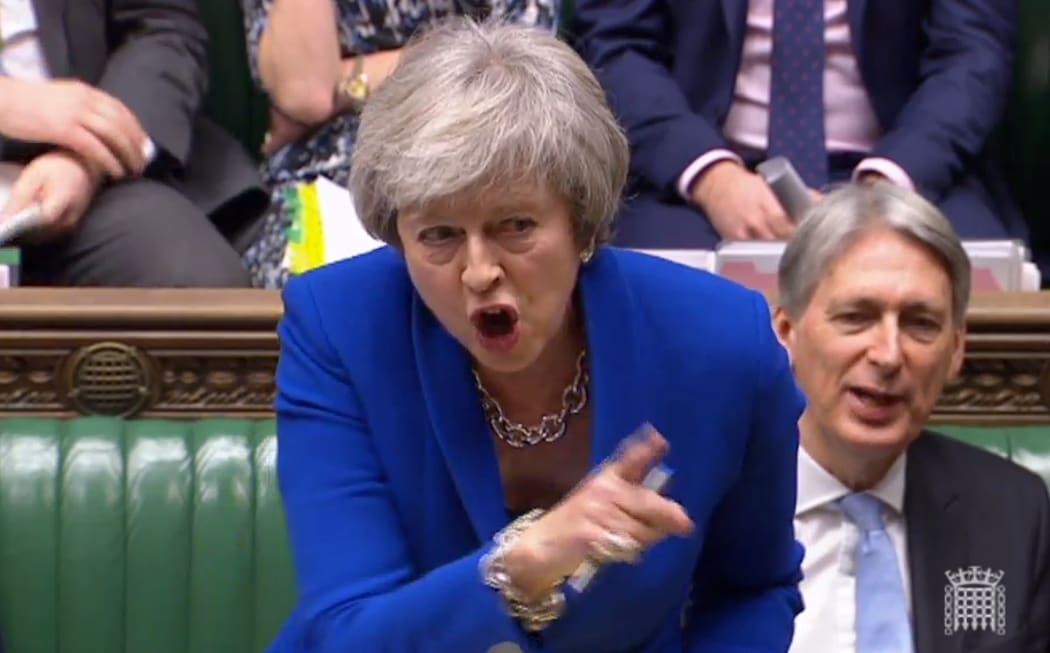 Britain's Prime Minister Theresa May tells makes a joke about the opposition Labour party leader Jeremy Corbyn's failure to demand a no-confidence vote against her government, during the weekly Prime Minister's Questions in the House of Commons in London on December 19, 2018.