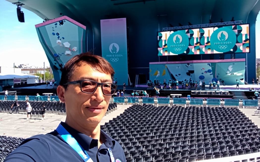 Nelson Lam a sport climbing judge from New Zealand taking a selfie at the climbing venue at the Paris Olympic Games.