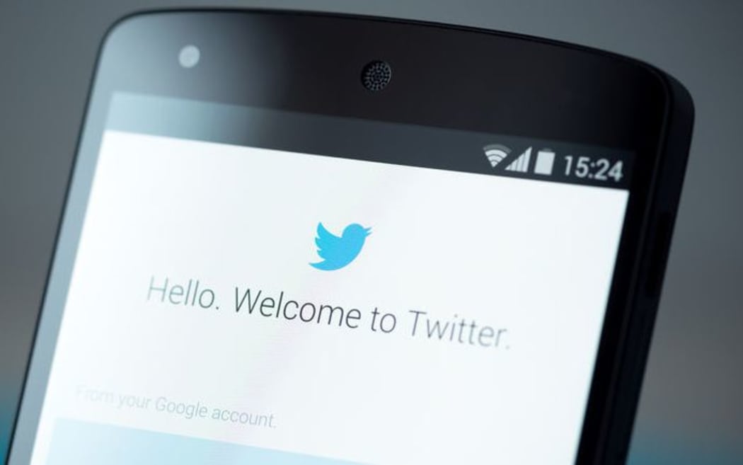 Twitter logo on cellphone screen