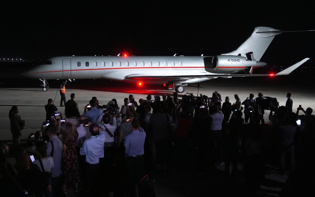 A plane carrying Paul Whelan, Evan Gershkovich and Alsu Kurmasheva, all prisoners freed by Russia, sits parked on the tarmac at Joint Base Andrews on August 1, 2024 at Joint Base Andrews, Maryland. Their release, negotiated as part of a 24 person prisoner exchange with Russia that involved at least six countries, is the largest prisoner exchange in post-Soviet history.