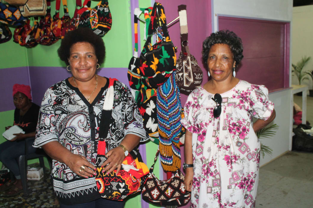 Two PNG women at the market selling their bilum bags