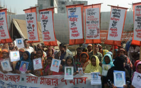 Survivors and relatives of Bangladeshi garment workers killed in the Tazreen Fashions fire accident and Rana Plaza garment factory building collapse react gather for a demonstration in Savar, on the outskirts of Dhaka on November 24, 2013.