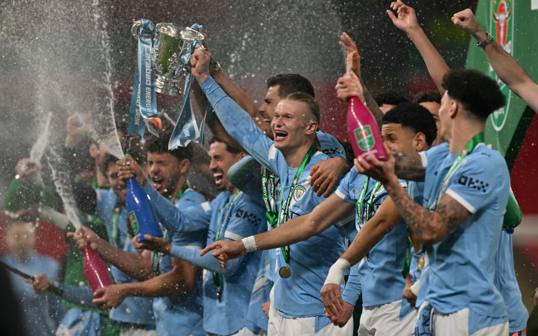 Manchester City's players celebrate winning the League Cup final against Arsenal.