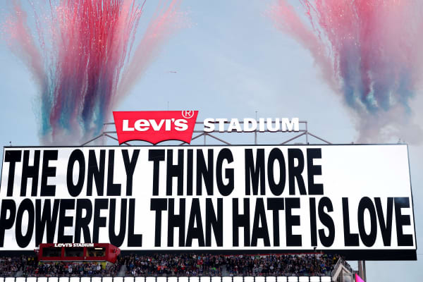 Signage that reads "The Only Thing More Powerful than Hate is Love" is displayed on the scoreboard during the Apple Music Super Bowl LX Halftime Show at Levi's Stadium on 8 February, 2026 in Santa Clara, California.
