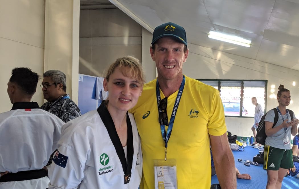 One of Australia's 10 takewondo gold medallists on Wednesday, Carmen Marton, with Chef de Mission Kenny Wallace.