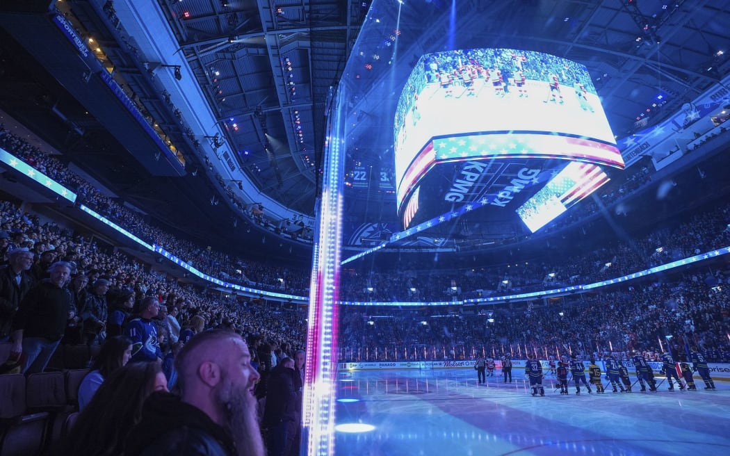 Fans boo as the US national anthem is sung before the Vancouver Canucks and Detroit Red Wings play an NHL hockey game in Vancouver, British Columbia.