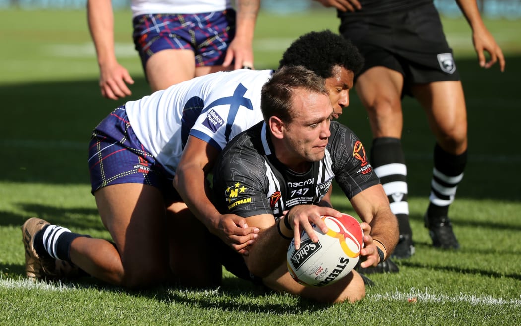 Jason Nightingale goes into score for the Kiwis against Scotland.