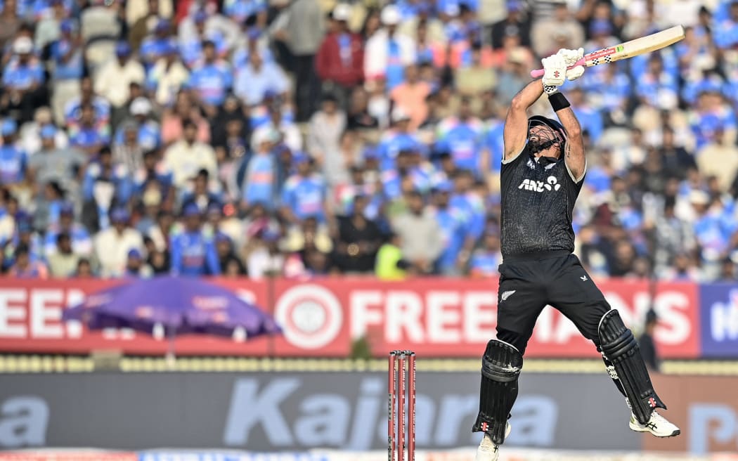 New Zealand's Daryl Mitchell tries to play a shot during the first one-day international (ODI) cricket match between India and New Zealand at the Kotambi Stadium in Vadodara on January 11, 2026.