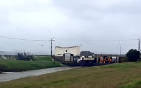 Council workers keeping one of Napier's main stormwater drains clear where it enters Pandora Estuary