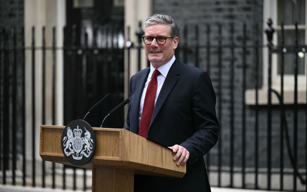 Britain's incoming Prime Minister Keir Starmer and leader of the Labour Party, stands at the podium as he addresses the nation following his general election victory, outside 10 Downing Street in London on July 5, 2024, a day after Britain held a general election. Starmer became Britain's new prime minister, as his centre-left opposition Labour party swept to a landslide general election victory, ending 14 years of right-wing Conservative rule. (Photo by Oli SCARFF / AFP)