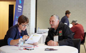 A Vietnam veteran completing a quick health and wellbeing assessment with a healthcare professional from HealthCare New Zealand