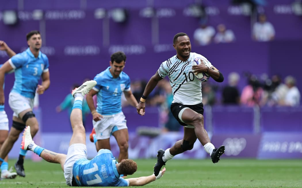 Fiji’s Iowane Teba breaks through the Uruguay defense for a try on day one of the Paris 2024 Olympic Games at Stade de France on 24 July, 2024 in Paris. Photo credit: Mike Lee - KLC fotos for World Rugby