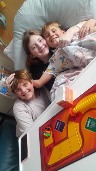 Amelia in hospital with brothers Lachie, left, and Harry.