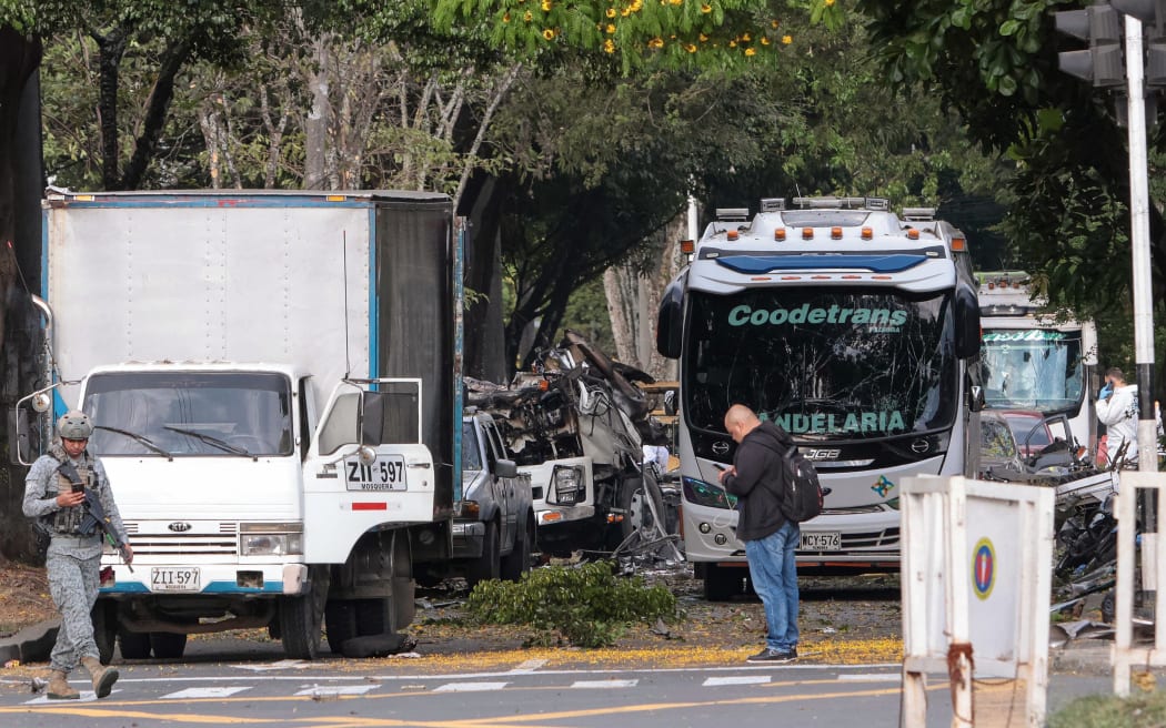 Members of Colombian security forces inspect the area of a bomb explosion in cali, Colombia on August 21 2025. Five people were killed and dozens were injured when a vehicle bomb targeted a military base on a busy street in the Colombian city of Cali on August 21, 2025, local authorities said. (Photo by Iusef Samir Rojas / AFP)
