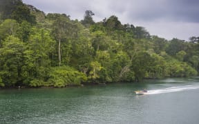 A boat on a river in the jungle of Manus Island