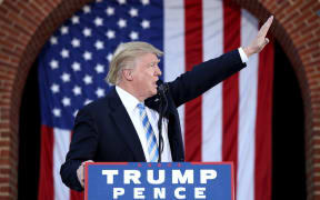 Donald Trump waves to supporters as he campaigns in Virginia, 22 October 2016.