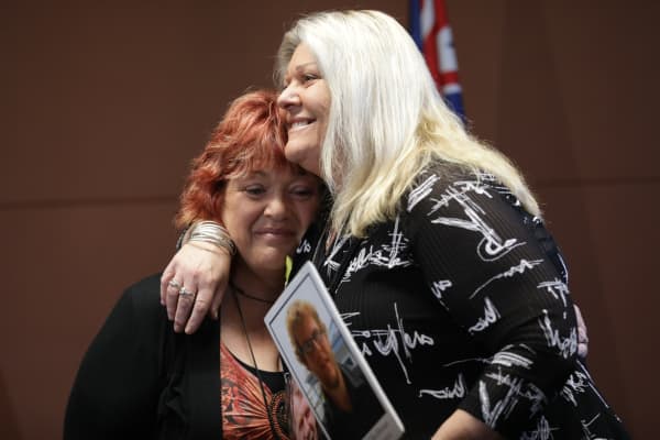 Relatives of mine victims Anna Osborne and Sonya Rockhouse embrace after the announcement of the re-entry plan.