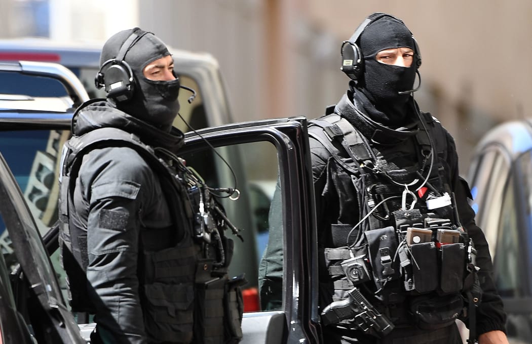 Members of the French RAID police unit leave after searching the home of one of two men arrested in Marseille on April 18, 2017