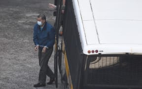 Jimmy Lai is seen handcuffed as he exits a prison van at Lai Chi Kok Reception Centre.