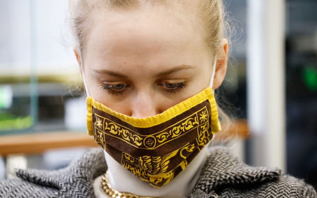 A woman wearing a face mask is seen in Warsaw, Poland on March 3. New cases of Covid have surged in the Warmian-Mazurian Voivodship, one of the country's poorest regions. As hospitals run out of beds the government has impose a lockdown in the region.
