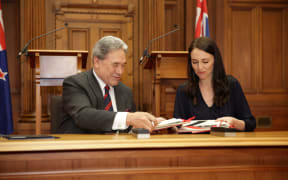 Jacinda Ardern and Winston Peters signing the coalition agreement.