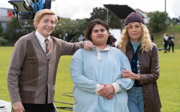 Rhys Darby as Brother Madigan Julian Dennison as Josh Waaka and Minnie Driver as Shirley Waaka in Uproar.