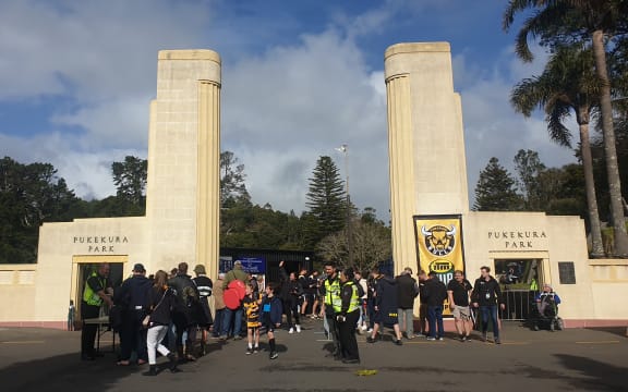 Fans stream through the gates into Pukekura Park.